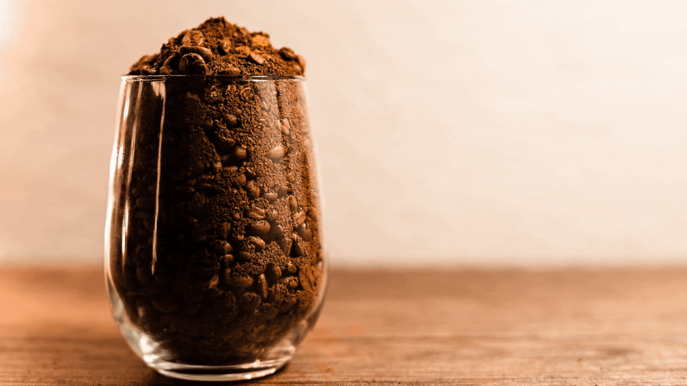 5 unique ways to use your coffee beans by cococino gourmet coffee. With an image of coffee grounds and beans in a coffee on a table 